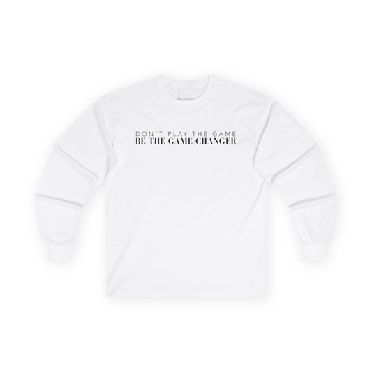 A long sleeve white t-shirt with black letters that say don't play the game be the game-changer across the chest
