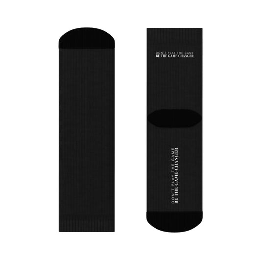 black socks with black accents on the toes and heel and black text on the back and bottom of the sock that says don't play the game be the game-changer