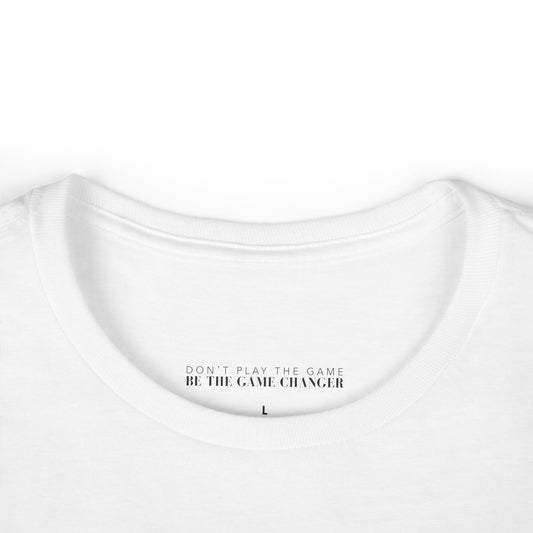 A close up of a white short sleeve t-shirt with a visible label that says don't play the game be the game-changer in black text 