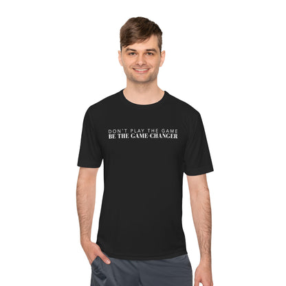 A smiling man with short brown hair and hazel eyes wearing a short sleeve black t-shirt with white letters that say don't play the game be the game-changer across the chest