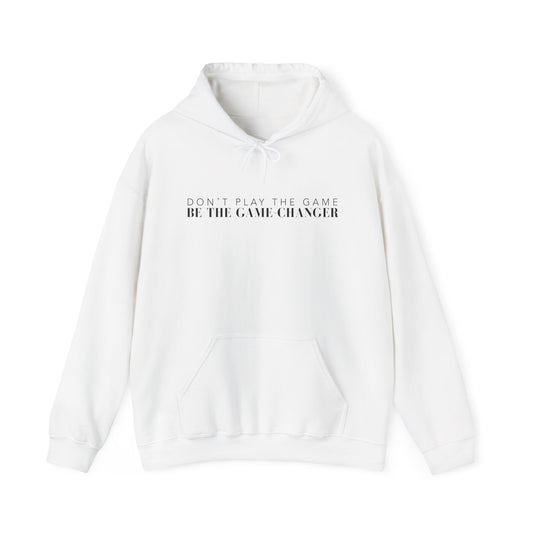 A white hoodie with draw strings, a kangaroo pocket, and black letters that say don't play the game be the game-changer across the chest